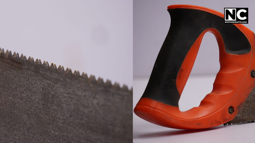 closeup of a cross cut saw teeth and handle